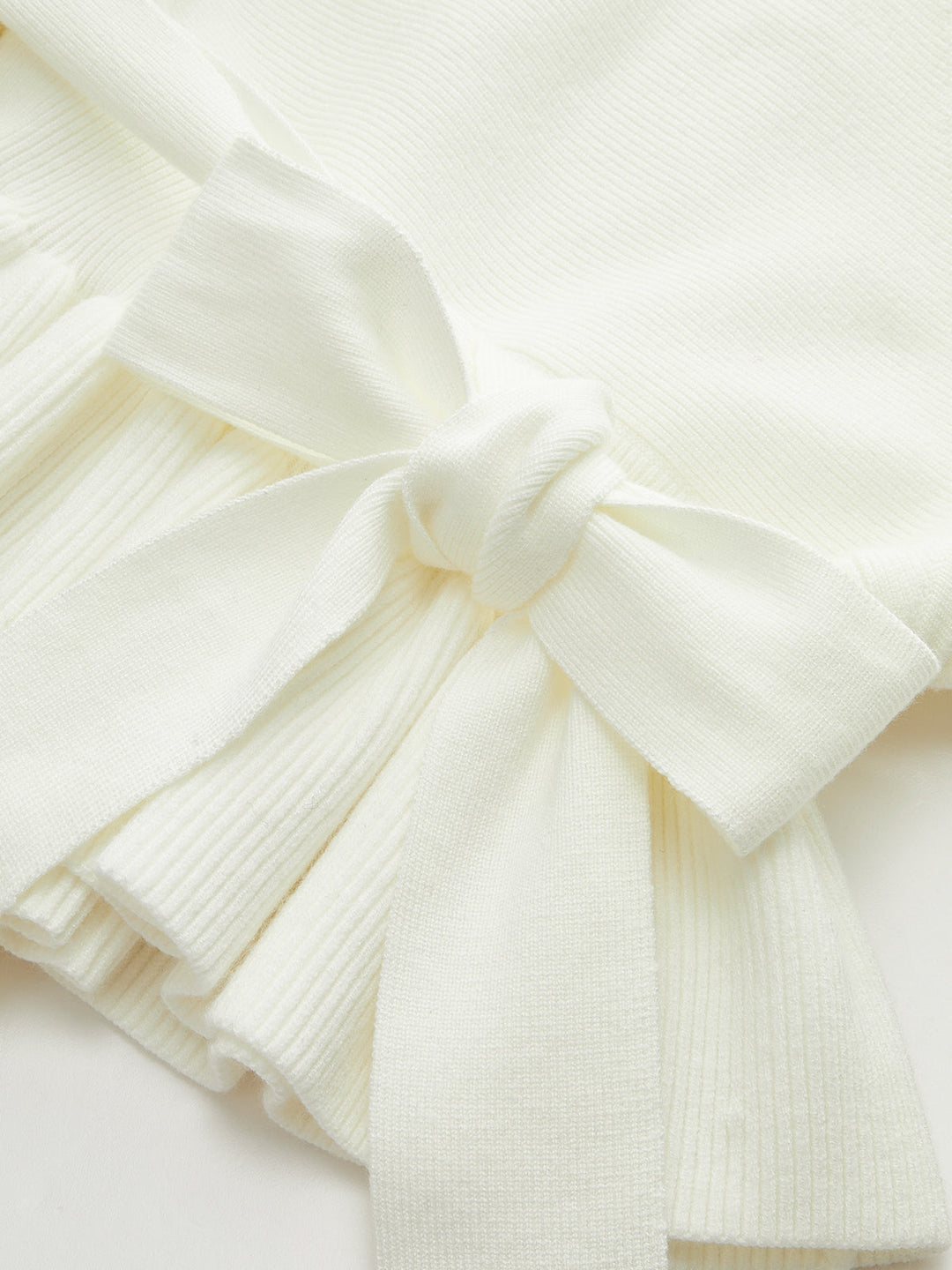 Enya – Strickoberteil mit Schleife und Schößchen